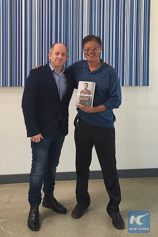 Duncan Clark with Yahoo co-founder Jerry Yang holding a copy of Clark's new Alibaba book. (Credit: Duncan Clark)