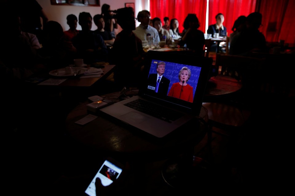 Damir Sagolj / Reuters  People watch a direct broadcast of first U.S. presidential debate in Beijing, China, September 27, 2016. 